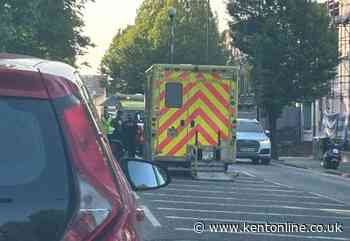 Police and medics block street after collision between pedestrian and motorbike