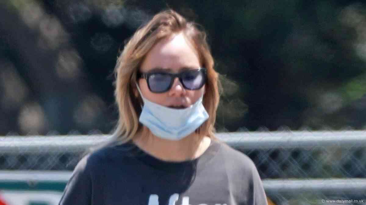 Masked Suki Waterhouse cuts a trendy figure in a slogan T-shirt as she enjoys a hike in LA after welcoming her first child with her fiancé Robert Pattinson