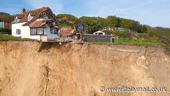 Demolition begins on £132,000 farmhouse teetering on the edge of 150ft cliff after owner is forced to evacuate - as neighbour insists the only way he'll leave is 'in a coffin'