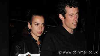 Dua Lipa looks edgy in a biker jacket and Gucci logoed trousers as she and Callum Turner hold hands during a late night exit from London hotspot