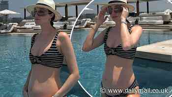 Pregnant Megan McKenna shows off her blossoming baby bump in a striped bikini during Dubai babymoon