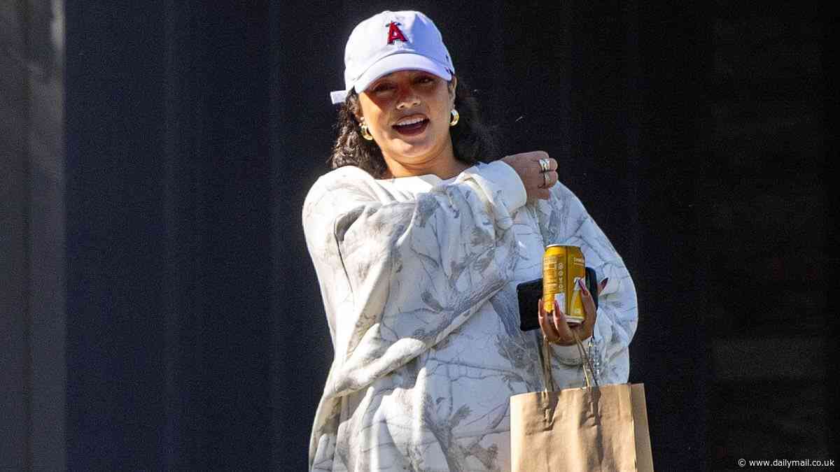 Vanessa Hudgens covers up her baby bump with an oversized sweatshirt while picking up groceries in Los Angeles