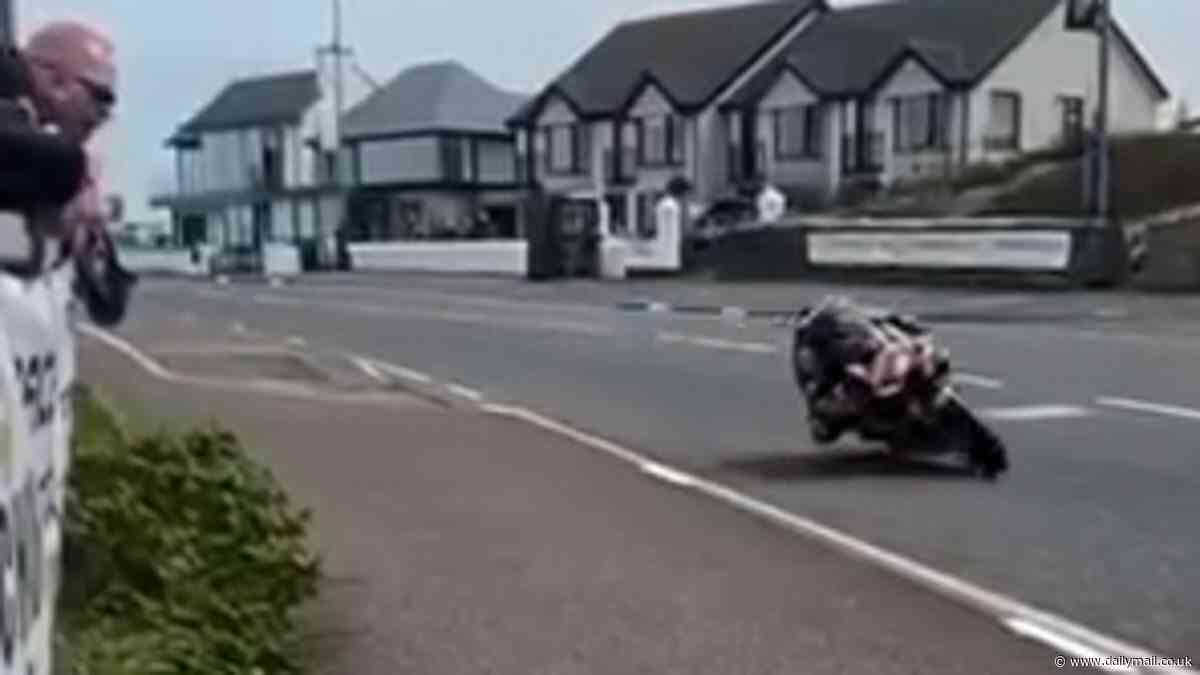 Terrifying moment biker crashes at high speeds into a barrier and somersaults 25ft into the air - before walking away unscathed