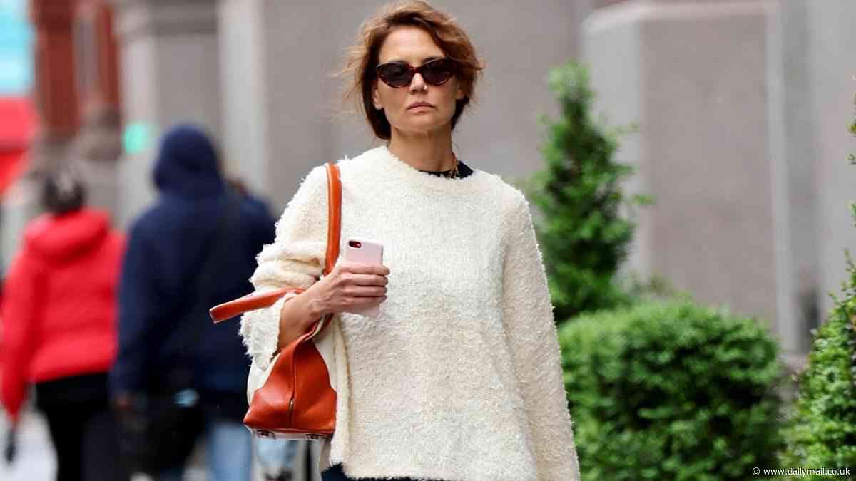 Katie Holmes is on-trend in baggy blue jeans and sweater as she braves rain without a jacket in NYC