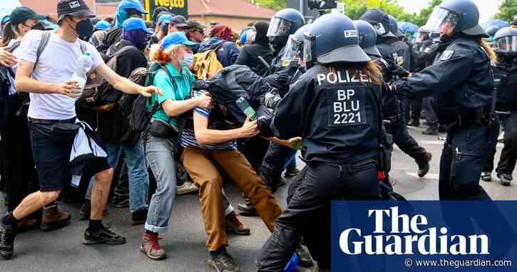 Germany: police clash with hundreds of climate protesters trying to storm Tesla plant – video