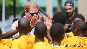 The king of the court! Harry and Meghan meet young Lagos students on basketball court (and the Duke even shows off his dance moves)