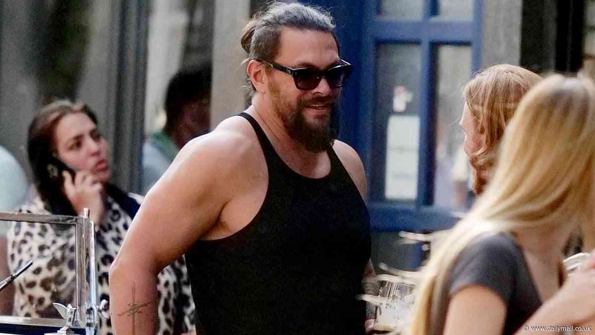 Jason Momoa shows off his passion for classic vehicles while cruising with friends in vintage convertible Bentley along streets of Soho in London