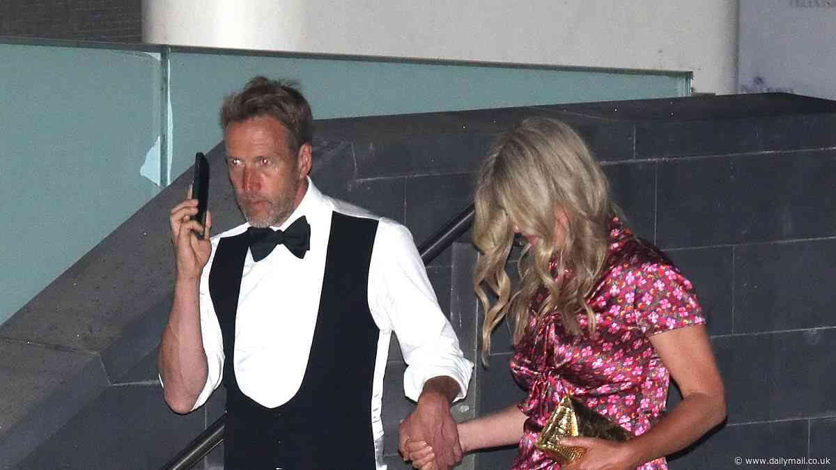 Bleary-eyed Ben Fogle leaves the BAFTA TV Awards with his wife Mariana as he helps her down the steps while talking on the phone after failing to scoop gong at the ceremony