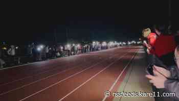 Students light the night with cell phones after Winona track meet goes dark