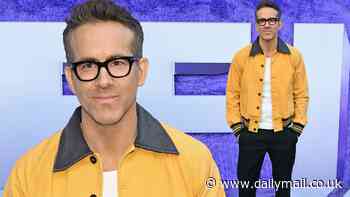 Ryan Reynolds cuts a smart figure in glasses and yellow bomber jacket as he walks the red carpet solo at the IF premiere in New York City