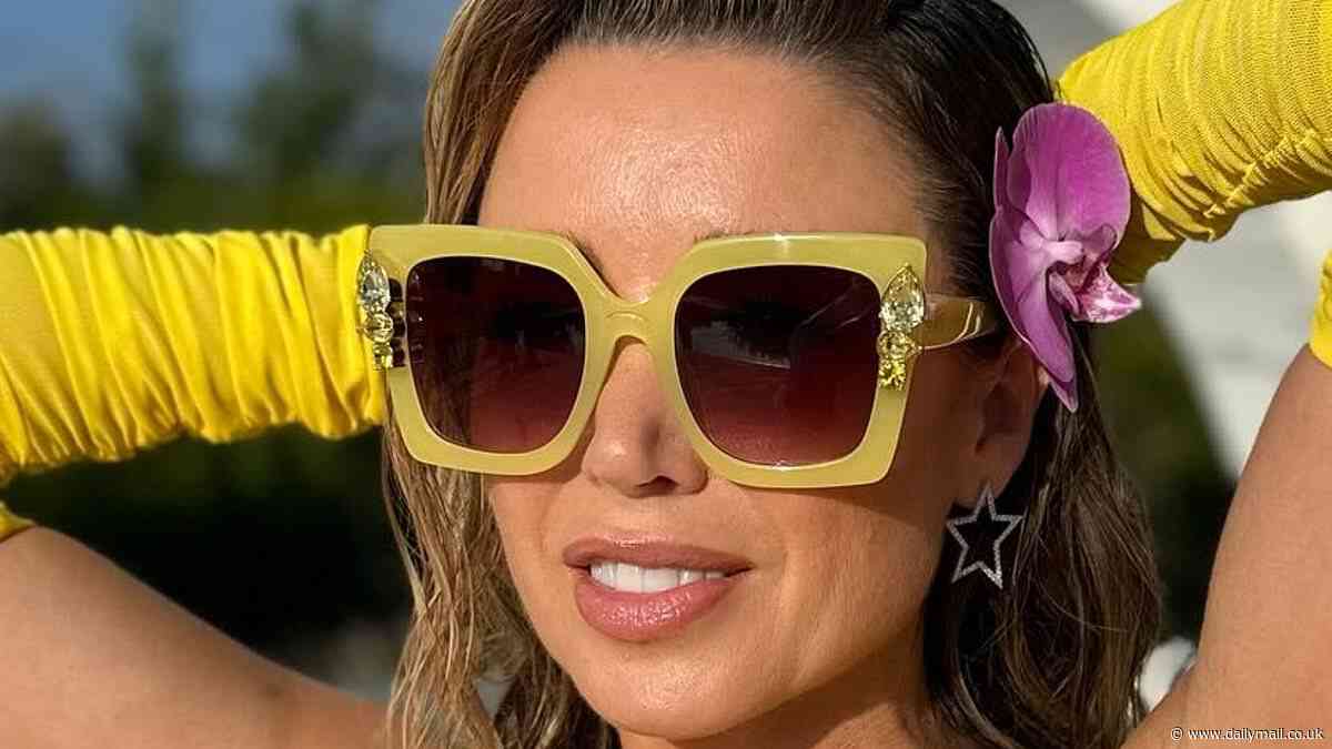 Dannii Minogue, 52, flaunts her incredible figure in a plunging yellow dress for sexy poolside snaps as she shares behind-the-scenes secrets from I Kissed A Girl