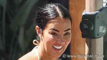 Yazmin Oukhellou beams in a tiny brown and cream zig zag-patterned string bikini as she holidays with friends in Ibiza