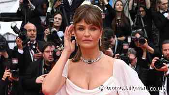 Helena Christensen, 55, stuns in a white Grecian gown as she leads the arrivals alongside chic Taylor Hill and Shanina Shaik at the Second Act premiere on the first day of Cannes Film Festival