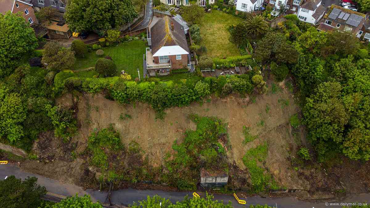 Living on the edge! House teeters perilously close to the cliff face as engineers desperately work to prevent further erosion