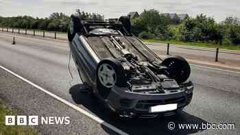 Driver 'frightened by spider' flips car
