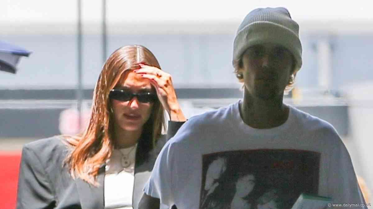 Hailey Bieber proudly parades bare baby bump in crop top for first time with Justin Bieber after keeping pregnancy secret for SIX MONTHS... but where's his new wedding ring?