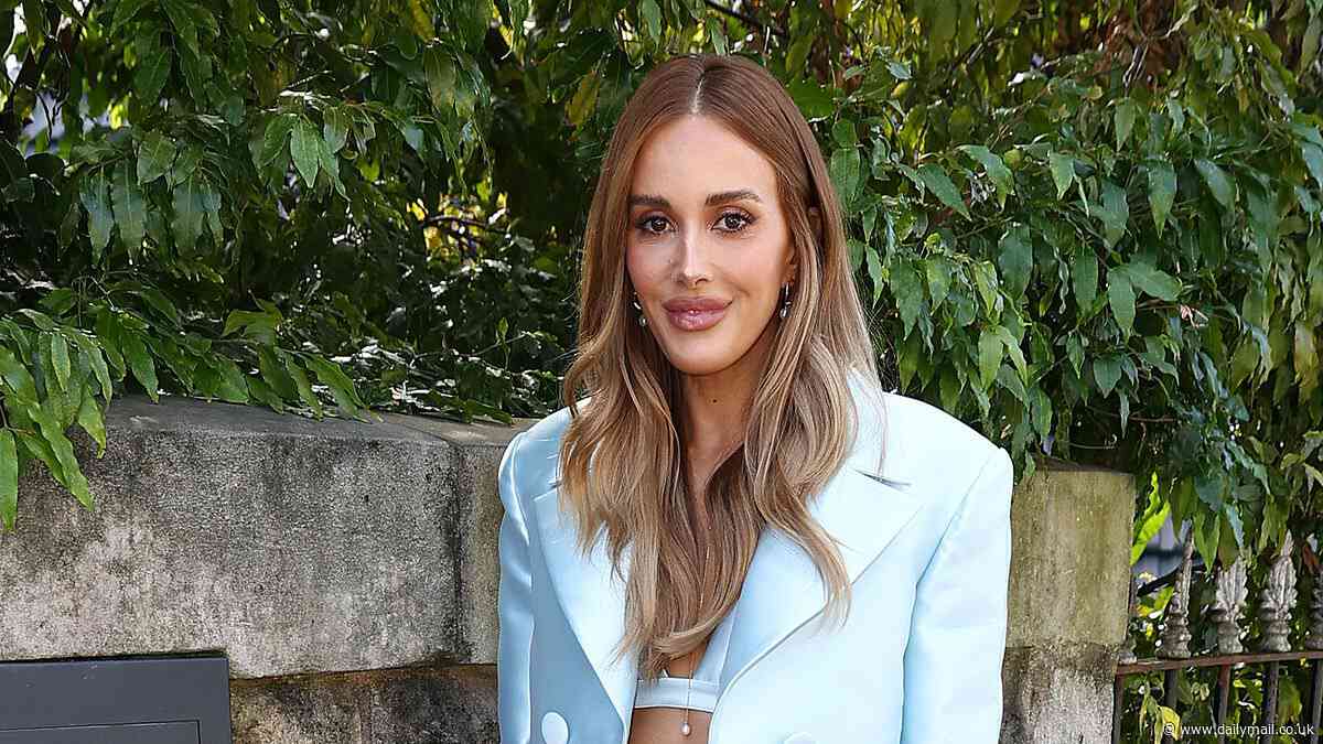 Rebecca Judd puts on a very leggy display in a blue satin mini skirt and cropped blazer as she leads the arrivals at AFW's Pandora Essence launch