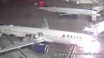 Passengers flee down emergency slides as Delta plane catches fire on airport tarmac