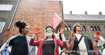 Honderden demonstranten lopen - luidkeels zingend - protestmars richting bestuurders van Radboud Universiteit