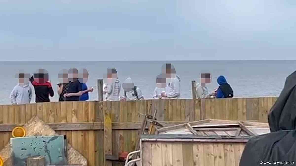 Tensions in seaside hotspot blighted by massive cliff falls explode into violence as 'two children are shot' after ignoring warnings to stop playing on crumbling sand dunes