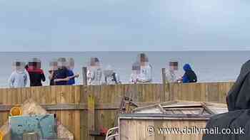 Tensions in seaside hotspot blighted by massive cliff falls explode into violence as 'two children are shot' after ignoring warnings to stop playing on crumbling sand dunes