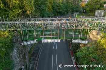 Historic iron bridge craned back into position as road reopens after four months