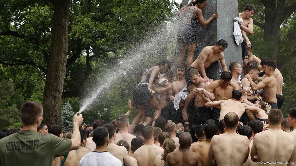 US Naval Academy ritual Herndon Monument Climb leaves Class of 2027 plebes covered in Crisco as their instructors take to them with the water hose