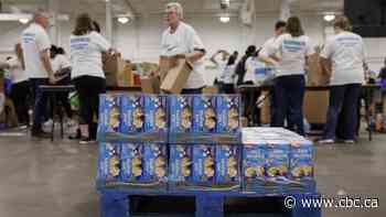 Volunteers pack healthy food for kids in need this summer