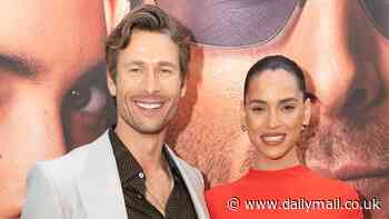 Glen Powell joins co-star Adria Arjona who sizzles in red hot gown as they lead stars at the premiere of their new Netflix action-comedy Hit Man in Texas