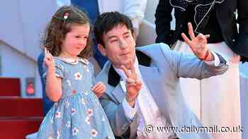Barry Keoghan joins young co-star Jackie Mellor, 4, on the Croisette as they flash peace signs at the 77th annual Cannes Film Festival premiere of Bird