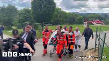 Robert Fico being wheeled into hospital on stretcher