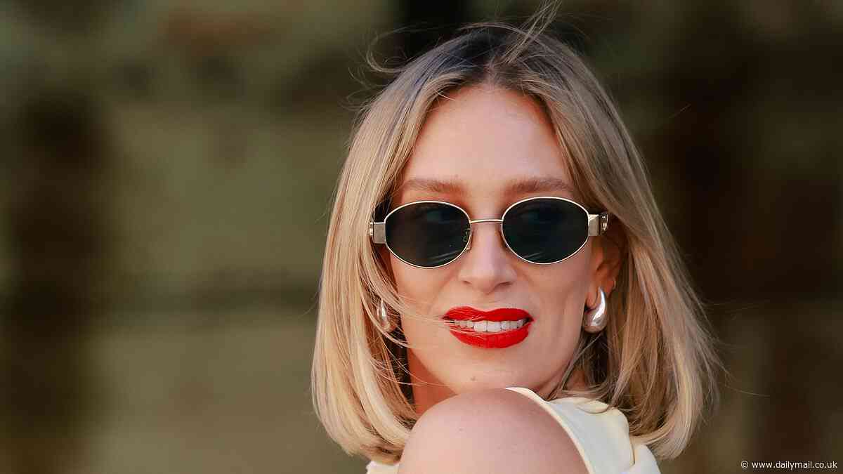 Phoebe Burgess puts on a glamorous display in pastel lemon ensemble as she returns to Australian Fashion Week following brutal snub