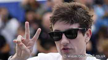 Barry Keoghan throws up a peace sign as he larks around during a photocall for his film Bird at Cannes Film Festival