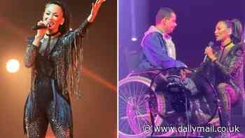 Nicole Scherzinger serenades star-struck fan in a wheelchair at Asia gig with her song Baby Love while wearing skintight sequin bodysuit