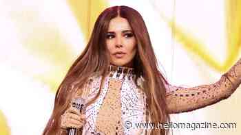 Cheryl is a vision in sheer catsuit with feathered detailing