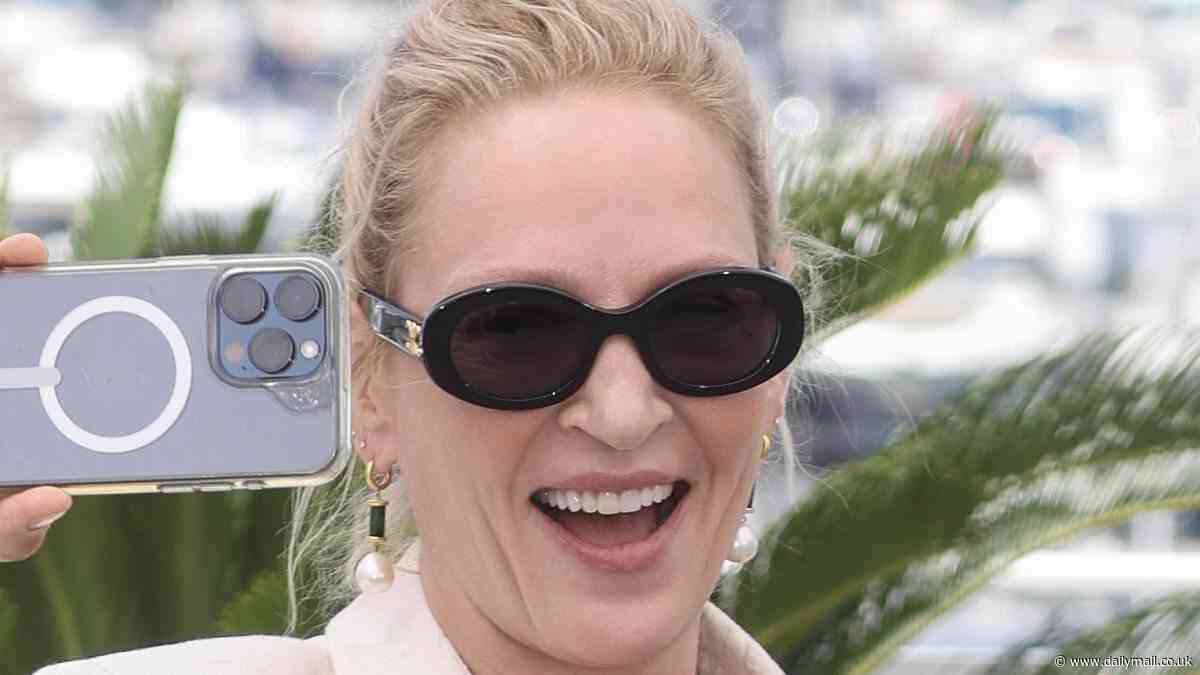 Cannes Film Festival: Uma Thurman, 54, is in high spirits as she playfully snaps selfies while posing in a floral cream skirt suit at the Oh, Canada photo call
