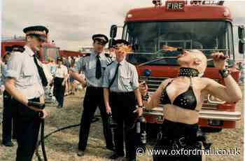 Firefighters watch a fire eater at the White Horse Show