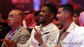 Cristiano Ronaldo and Anthony Joshua share a laugh at ringside as they sit next to each other for Tyson Fury's undisputed heavyweight clash against Oleksandr Usyk