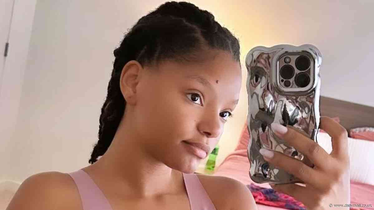 Halle Bailey shows off sculpted abs in pink sports bra... less than six months after giving birth to son Halo
