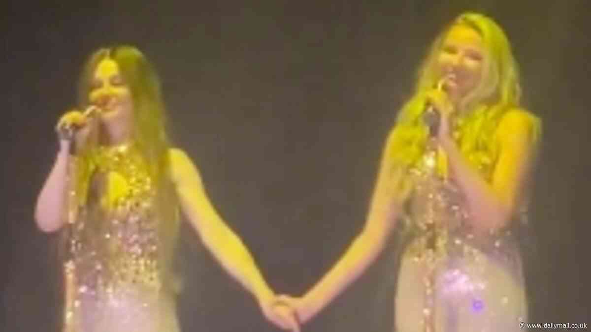 Emotional Cheryl and Nadine Coyle share a sweet moment as they supportively hold hands after heartbreaking Sarah Harding tribute during reunion concert