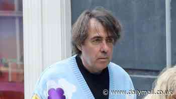 Jonathan Ross turns heads in a quirky Teletubbies cardigan as he walks his dogs with his wife Jane Goldman in London