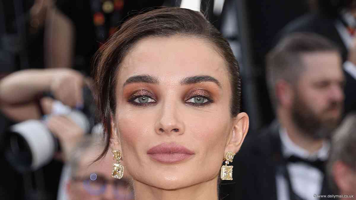 Amy Jackson turns heads in an elegant black evening gown with huge bouffant sleeves as she attends the 77th Cannes Film Festival premiere of Horizon: An American Saga