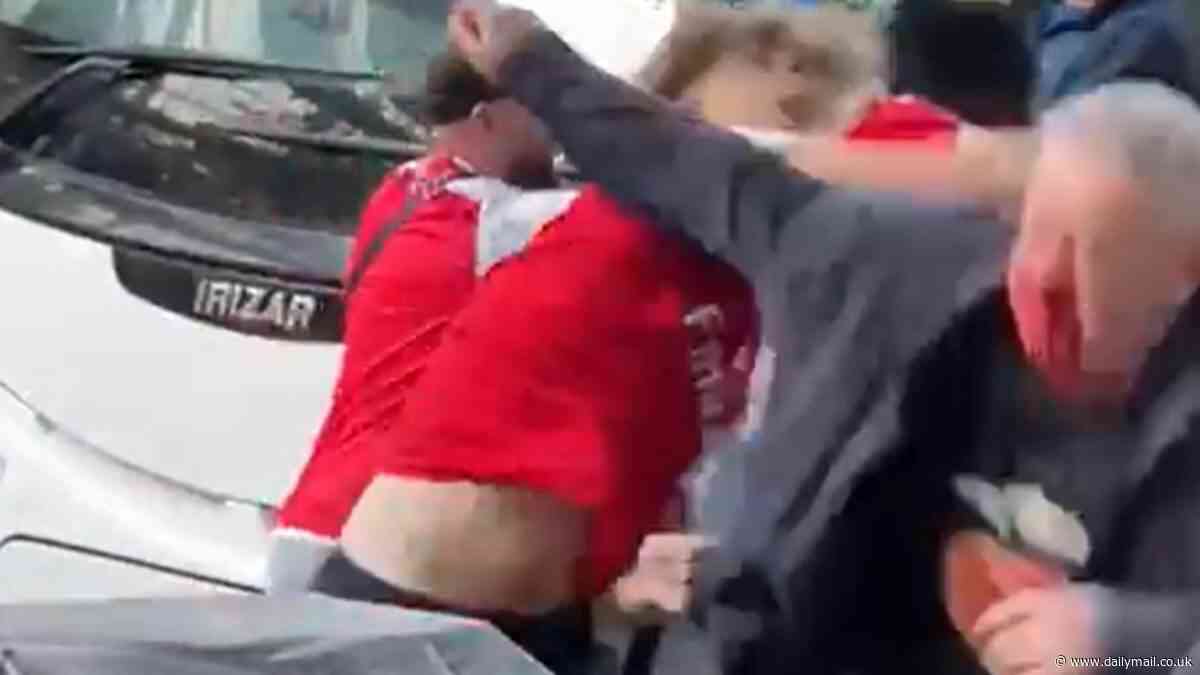 Shocking moment Everton fan is knocked out and squirted with sauce in violent clashes with Arsenal supporters at the Emirates... after the Gunners fell short in the Premier League title race