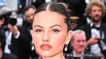 Thylane Blondeau cuts a glamourous figure in a clinging black dress as she attends the 77th annual Cannes Film Festival premiere of The Apprentice