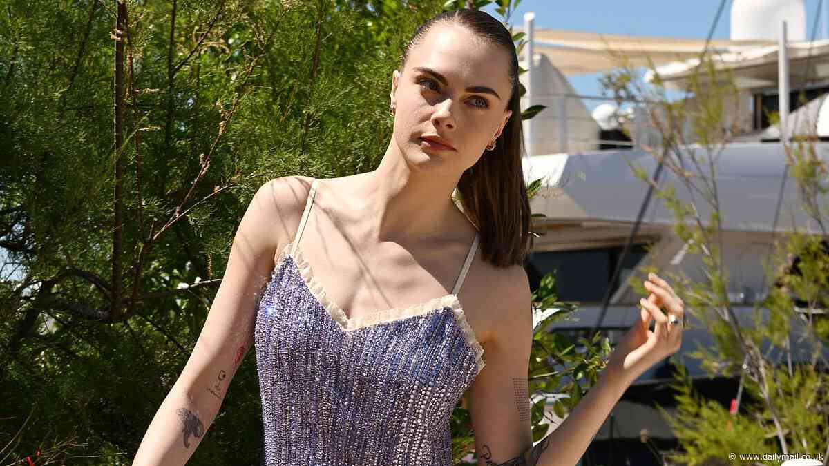 Cara Delevingne puts on a leggy display in a shimmering lilac slip dress as she steps out for Miu Miu summer event during Cannes Film Festival