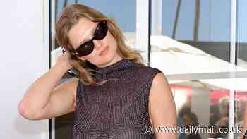 Toni Garrn wows in shimmery sheer purple dress and sunglasses as she enjoys another day at Cannes