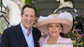 Joan Collins wows in leg-lengthening trousers and must-see hat alongside husband Percy Gibson