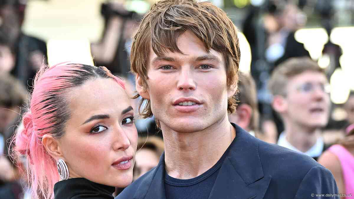Chiseled Jordan Barrett cuts a suave figure as he cuddles up to glamorous model Allegra Ream at the Marcello Mio premiere at Cannes Film Festival