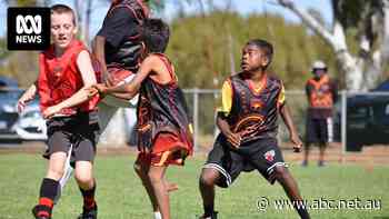Remote community travels 600km for first junior footy match in years