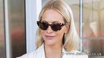 Poppy Delevingne looks effortlessly chic as she leaves the Hotel Martinez in a white pinstriped blazer and denim shorts during the Cannes Film Festival